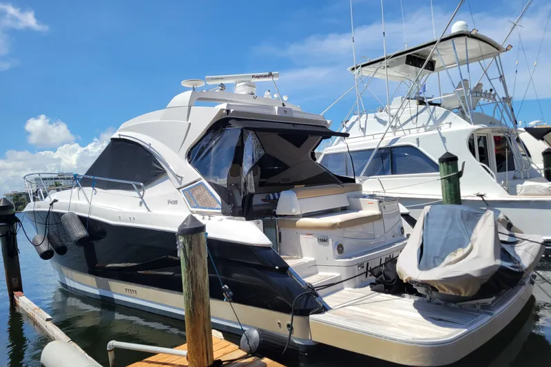 Isabella IV Yacht Photos Pics 2012 Four Winns V435 yacht docked at marina under clear blue sky.
