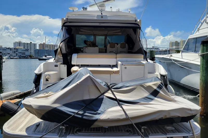 Isabella IV Yacht Photos Pics 2012 Four Winns V435 yacht docked, featuring spacious deck and covered seating area.