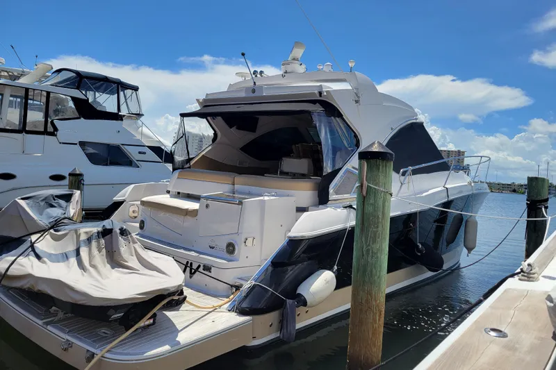 Isabella IV Yacht Photos Pics 2012 Four Winns V435 yacht docked at marina under clear blue sky.