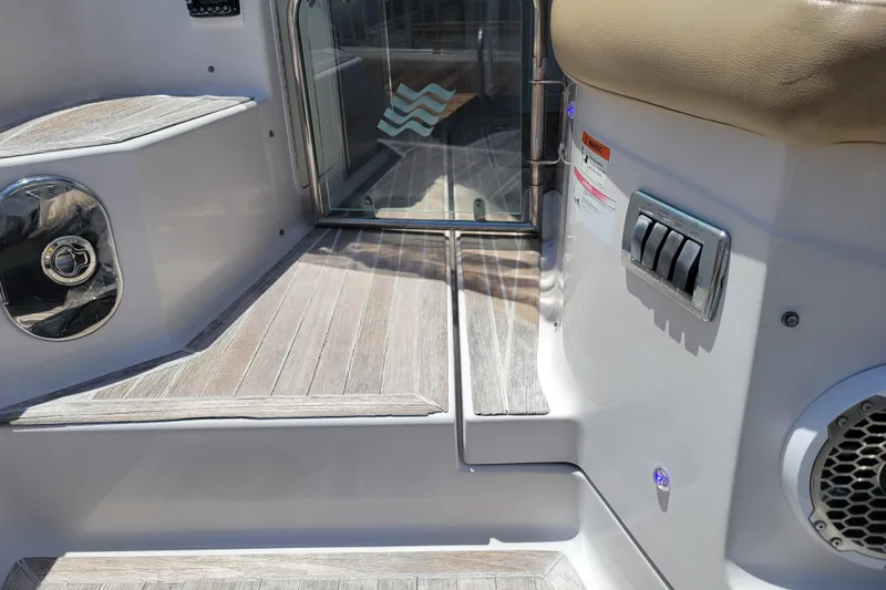 Isabella IV Yacht Photos Pics 2012 Four Winns V435 boat interior with wooden steps and control panel.