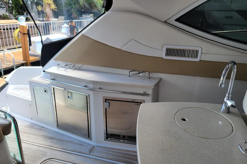 Isabella IV Yacht Photos Pics 2012 Four Winns V435 yacht interior with kitchenette, sink, and storage compartments.