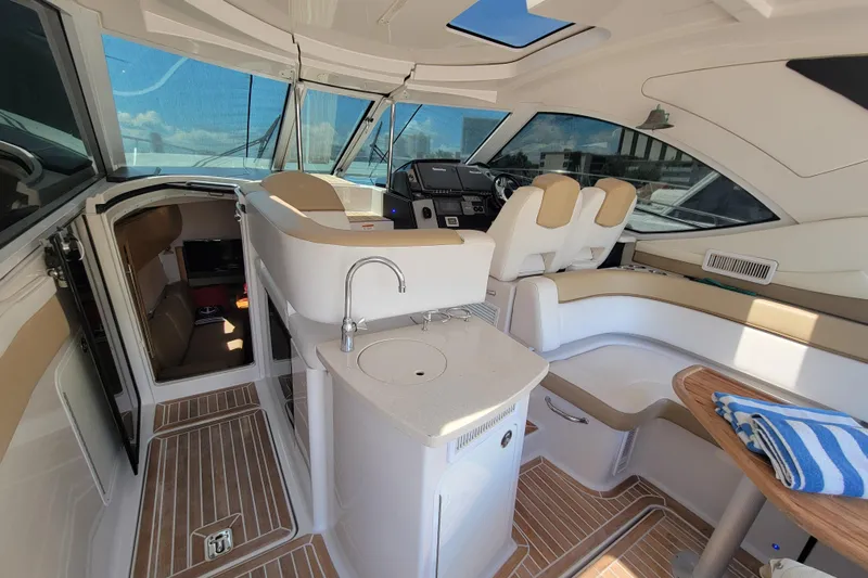 Isabella IV Yacht Photos Pics Interior of 2012 Four Winns V435 yacht with helm, seating, and kitchenette.