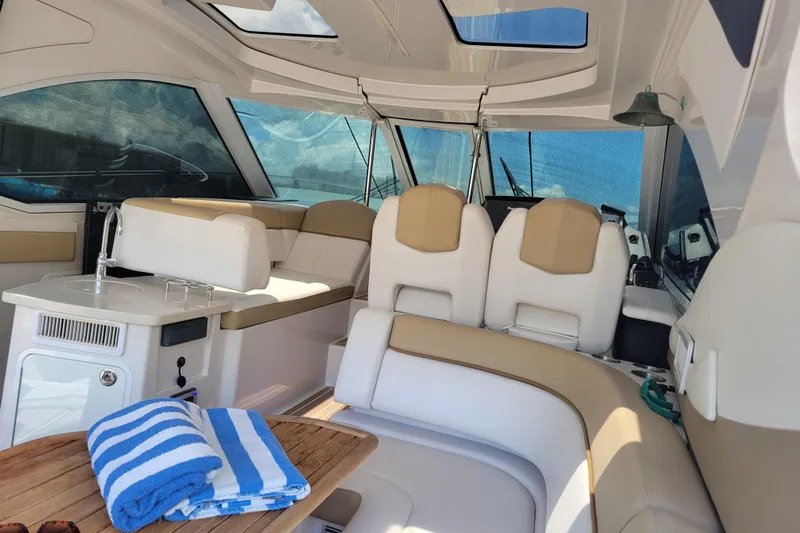 Isabella IV Yacht Photos Pics Interior of 2012 Four Winns V435 yacht with seating and striped towels.