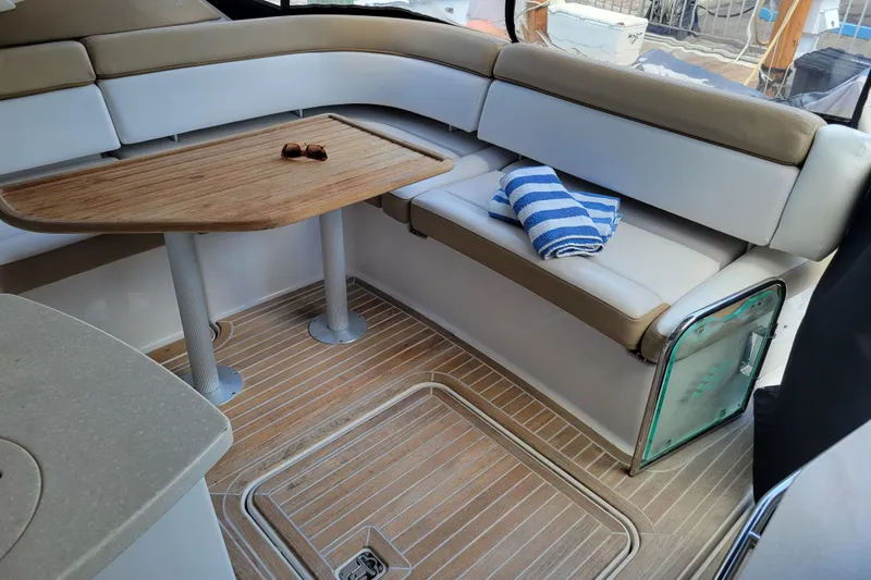 Isabella IV Yacht Photos Pics Interior of 2012 Four Winns V435 yacht with seating, table, and striped towel.