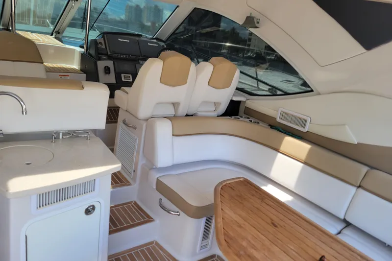 Isabella IV Yacht Photos Pics Luxurious interior of 2012 Four Winns V435 yacht with seating and kitchenette.