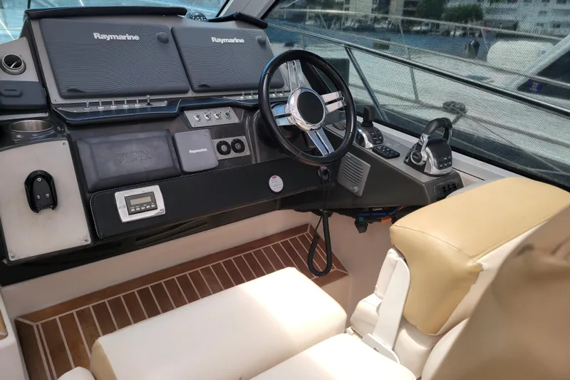 Isabella IV Yacht Photos Pics 2012 Four Winns V435 helm with Raymarine electronics and beige seating.