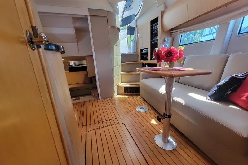 Isabella IV Yacht Photos Pics Luxurious 2012 Four Winns V435 yacht interior with elegant seating and wooden flooring.