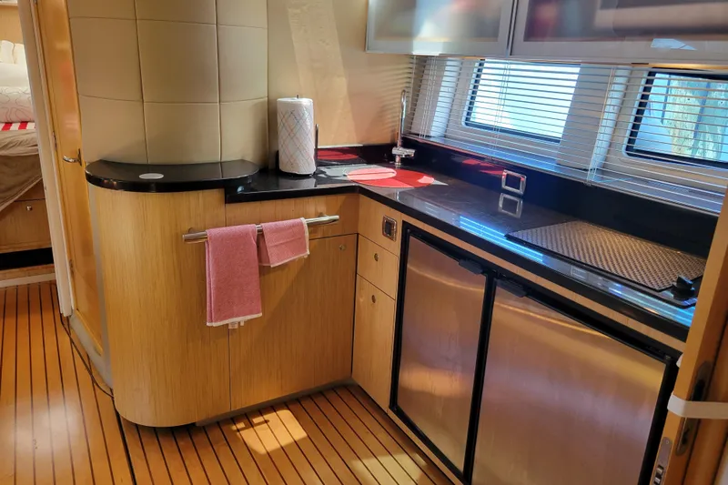 Isabella IV Yacht Photos Pics Luxurious 2012 Four Winns V435 yacht kitchen with sleek countertops and modern appliances.