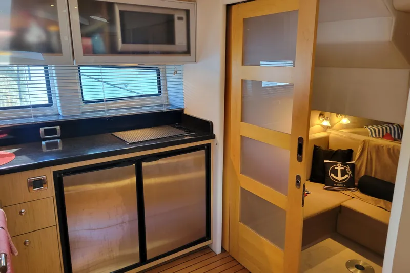 Isabella IV Yacht Photos Pics 2012 Four Winns V435 yacht interior with kitchenette and cozy seating area.