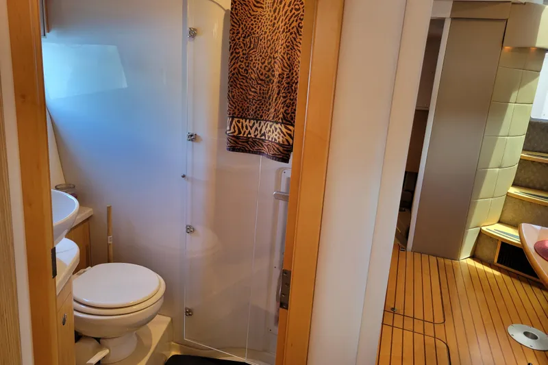 Isabella IV Yacht Photos Pics Bathroom interior of 2012 Four Winns V435 yacht with wooden flooring and modern fixtures.