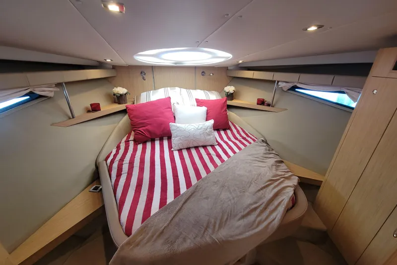 Isabella IV Yacht Photos Pics Luxurious 2012 Four Winns V435 yacht cabin with striped bedding and elegant decor.