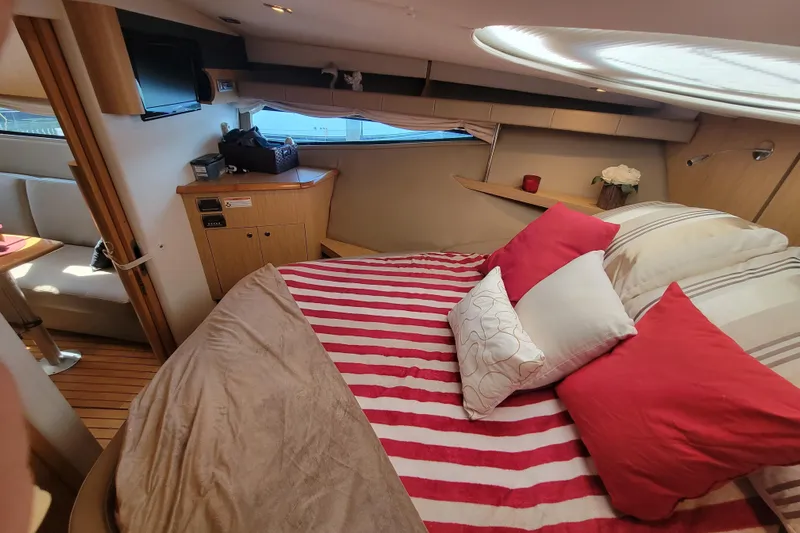 Isabella IV Yacht Photos Pics Luxurious 2012 Four Winns V435 yacht cabin with striped bedding and cozy decor.
