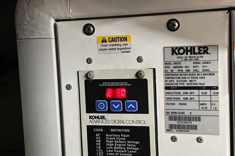 Isabella IV Yacht Photos Pics Kohler generator control panel on 2012 Four Winns V435 boat, displaying caution and specifications.