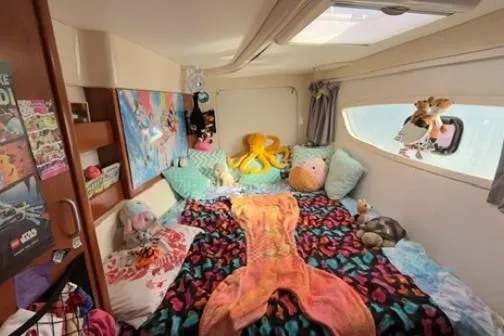 The Light Yacht Photos Pics Cozy Leopard 44 yacht cabin with colorful decor and plush toys, 2014 model.