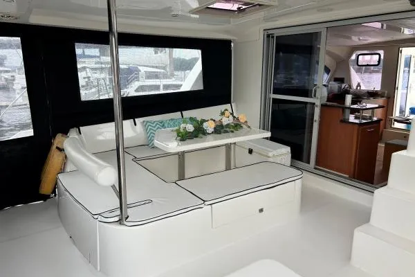 The Light Yacht Photos Pics Luxurious interior of 2014 Leopard 44 catamaran with elegant seating and dining area.