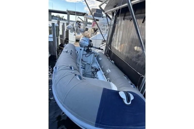 The Light Yacht Photos Pics Inflatable boat docked beside a 2014 Leopard 44 yacht, featuring a Honda outboard motor.