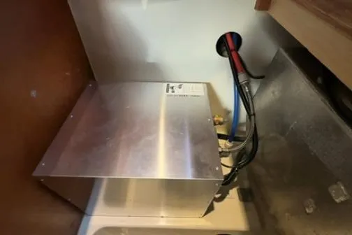 The Light Yacht Photos Pics Electrical installation inside a 2014 Leopard 44 yacht, featuring wiring and metal casing.