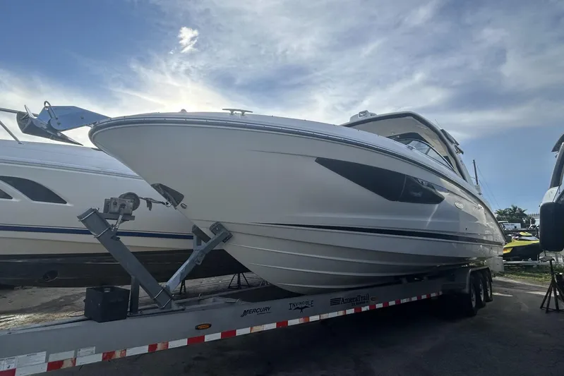  Yacht Photos Pics 2019 Sea Ray SLX 350 Outboard boat on trailer under a cloudy sky.