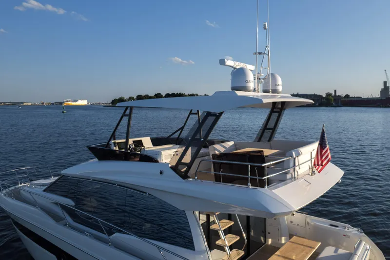  Yacht Photos Pics 2023 Prestige 520 F-Line yacht on calm water with clear sky.