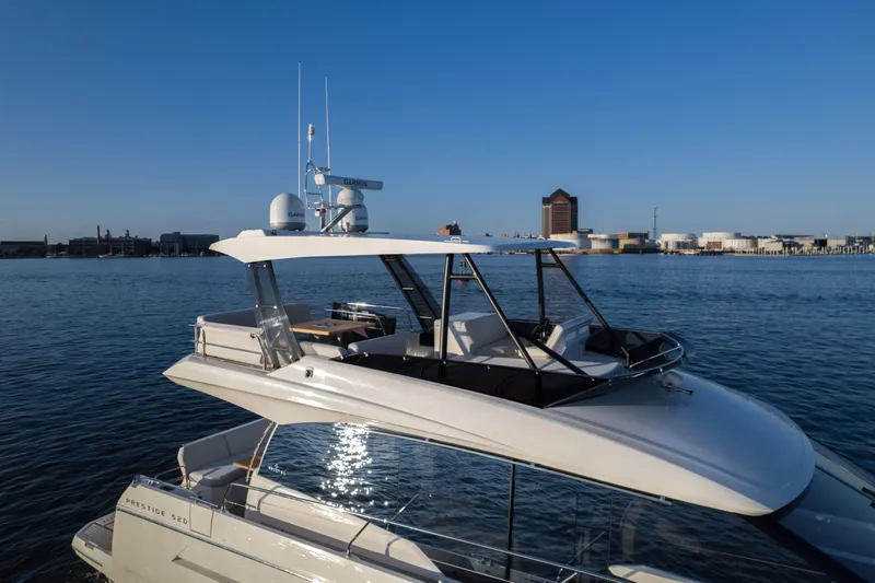  Yacht Photos Pics Prestige 520 F-Line yacht, 2023 model, cruising on calm waters under a clear blue sky.