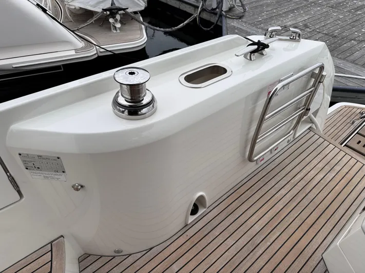  Yacht Photos Pics 2023 Prestige 520 F-Line yacht stern with winch and swim ladder on teak deck.