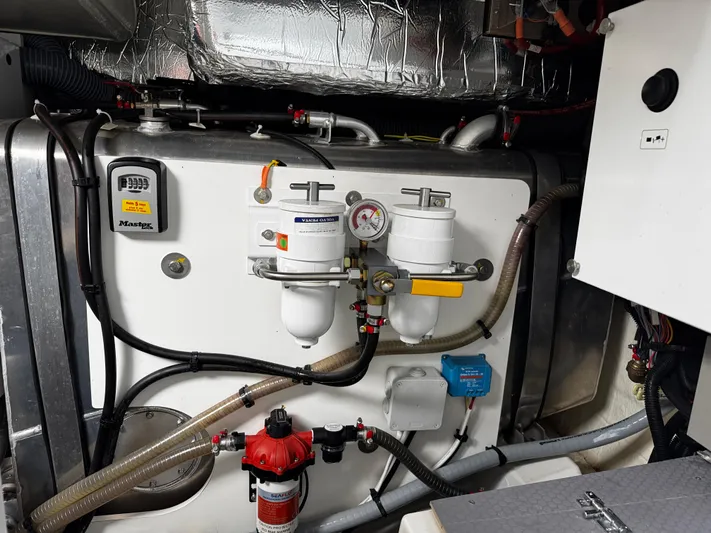  Yacht Photos Pics Engine room of 2023 Prestige 520 F-Line yacht, featuring fuel filters and mechanical components.