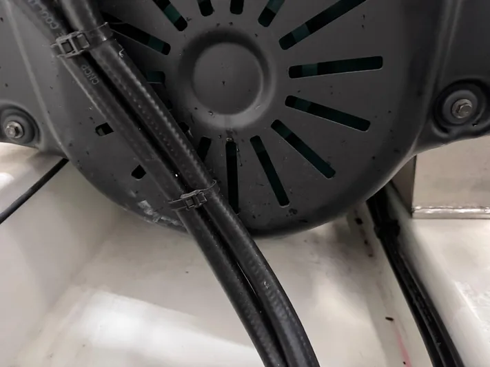  Yacht Photos Pics Close-up of 2023 Prestige 520 F-Line engine component with cables and ventilation slots.