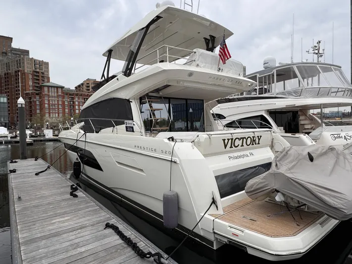  Yacht Photos Pics 2023 Prestige 520 F-Line yacht docked at marina, featuring sleek design and modern amenities.