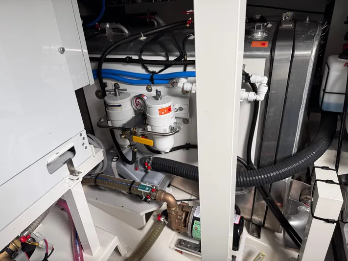  Yacht Photos Pics Engine room of 2023 Prestige 520 F-Line yacht, showcasing mechanical components and piping.