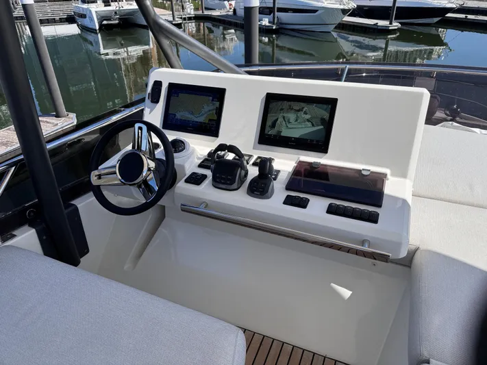  Yacht Photos Pics 2023 Prestige 520 F-Line yacht helm with dual screens and modern controls.
