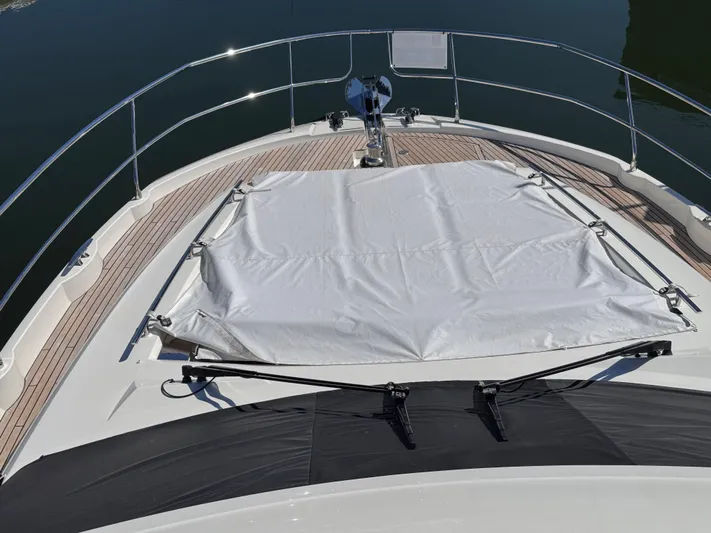  Yacht Photos Pics 2023 Prestige 520 F-Line yacht deck with sunbed cover and sleek railing design.