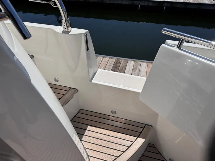  Yacht Photos Pics 2023 Prestige 520 F-Line yacht with sleek wooden steps and stainless steel railings.