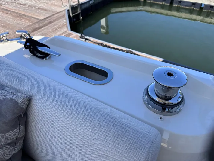  Yacht Photos Pics 2023 Prestige 520 F-Line yacht deck with cleat and winch by the water.