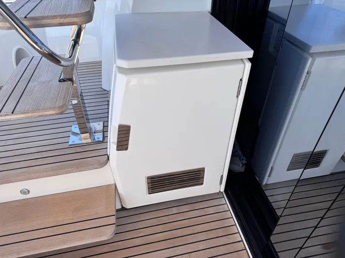  Yacht Photos Pics 2023 Prestige 520 F-Line yacht interior with wooden steps and compact white cabinet.