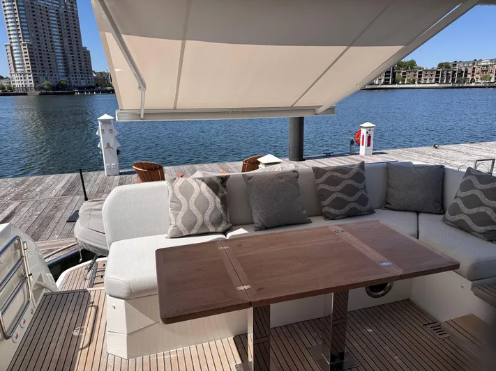  Yacht Photos Pics Luxurious 2023 Prestige 520 F-Line yacht deck with elegant seating and waterfront view.