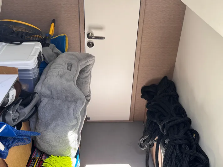  Yacht Photos Pics Storage area in a 2023 Prestige 520 F-Line yacht with various equipment and supplies.