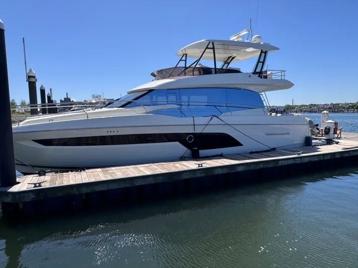  Yacht Photos Pics 2023 Prestige 520 F-Line yacht docked at marina under clear blue sky.