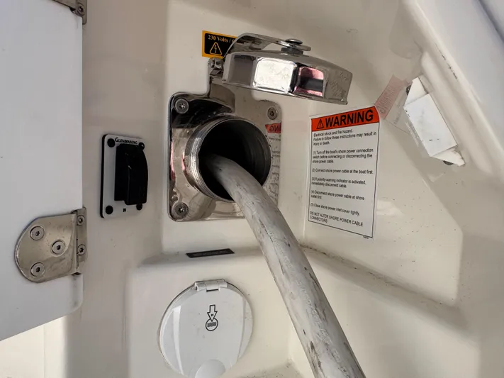  Yacht Photos Pics Fuel hose connected to a 2023 Prestige 520 F-Line yacht with warning labels visible.