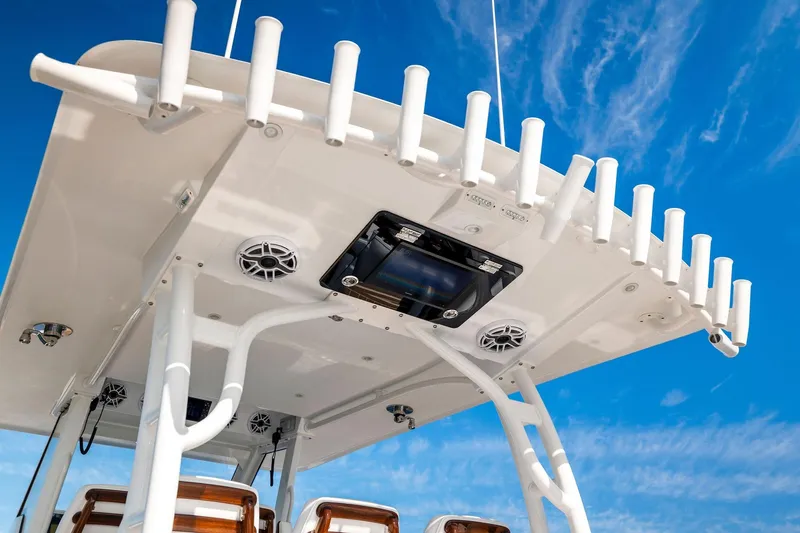  Yacht Photos Pics 2022 Barker Boatworks 40 HPC with rod holders and speakers against a blue sky.