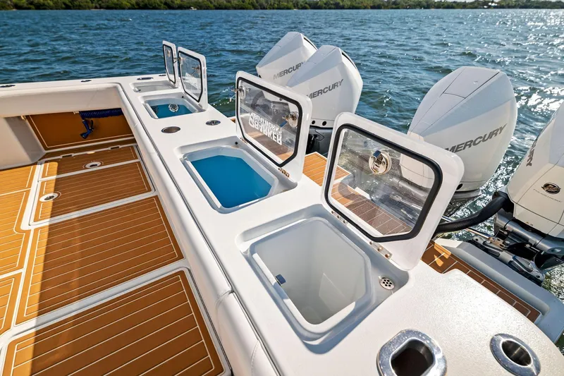  Yacht Photos Pics 2022 Barker Boatworks 40 HPC with open storage compartments and Mercury engines on the water.