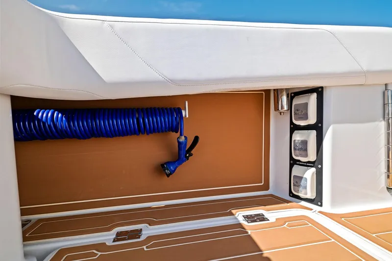  Yacht Photos Pics 2022 Barker Boatworks 40 HPC interior with coiled blue hose and SmartPlug outlets.