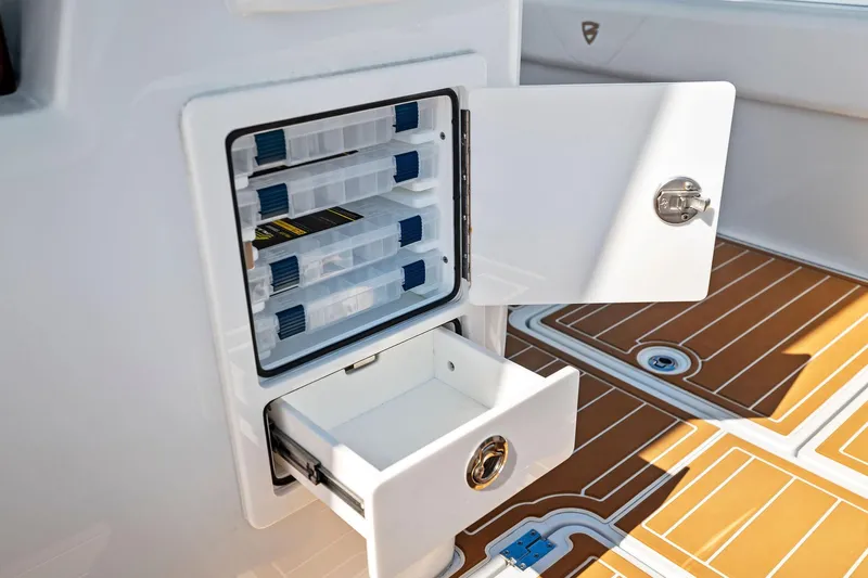  Yacht Photos Pics Storage compartment on 2022 Barker Boatworks 40 HPC, featuring organized tackle boxes and sleek design.