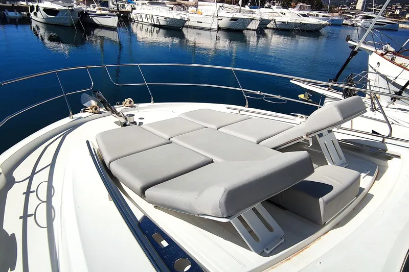  Yacht Photos Pics 2023 Jeanneau Prestige 520 Fly yacht with luxurious sunbathing area in marina.
