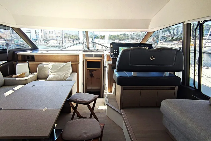  Yacht Photos Pics Luxurious interior of 2023 Jeanneau Prestige 520 Fly yacht with modern seating and helm.