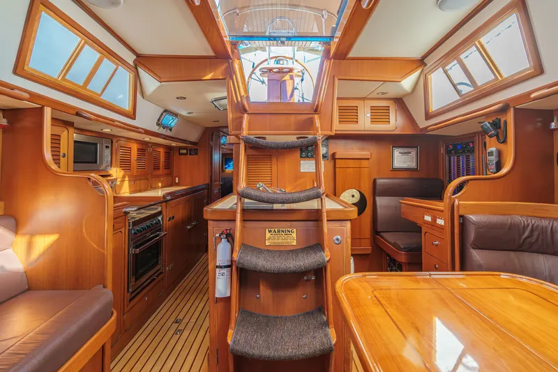 Feather Yacht Photos Pics Luxurious interior of a 2012 Hylas 46 yacht with wooden finishes and modern amenities.