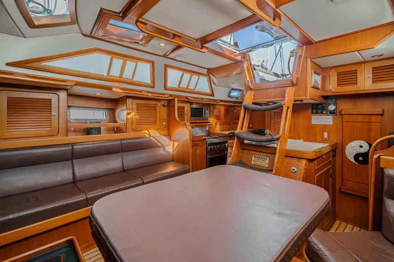 Feather Yacht Photos Pics Luxurious 2012 Hylas 46 yacht interior with wood finish and leather seating.