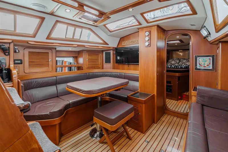 Feather Yacht Photos Pics Luxurious interior of a 2012 Hylas 46 yacht with wood finishes and leather seating.