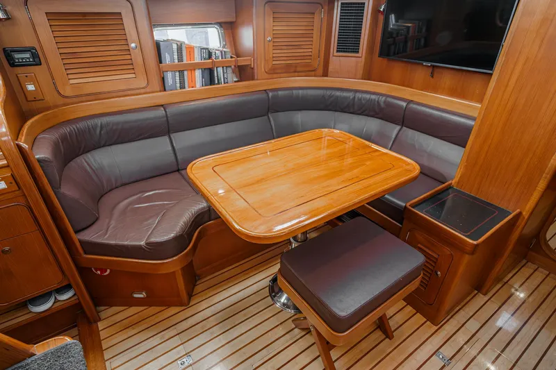 Feather Yacht Photos Pics Luxurious 2012 Hylas 46 yacht interior with wooden dining area and leather seating.