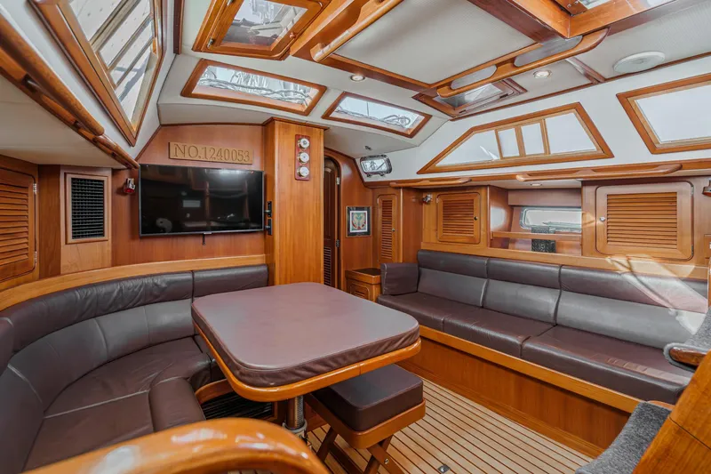 Feather Yacht Photos Pics Luxurious interior of a 2012 Hylas 46 yacht with wood finishes and skylights.