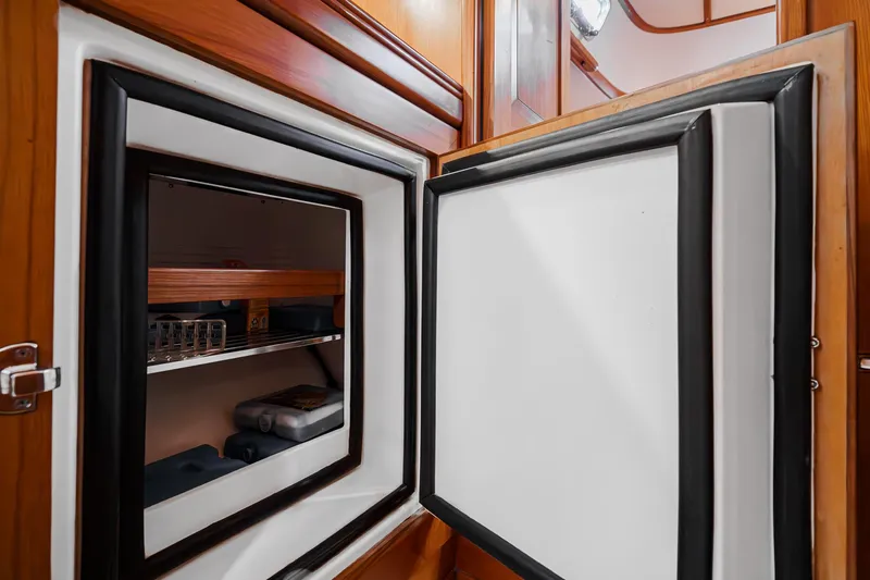 Feather Yacht Photos Pics Open refrigerator in 2012 Hylas 46 yacht interior, showcasing storage shelves.